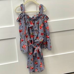 This is a romper with stripes and flower designs and a matching belt